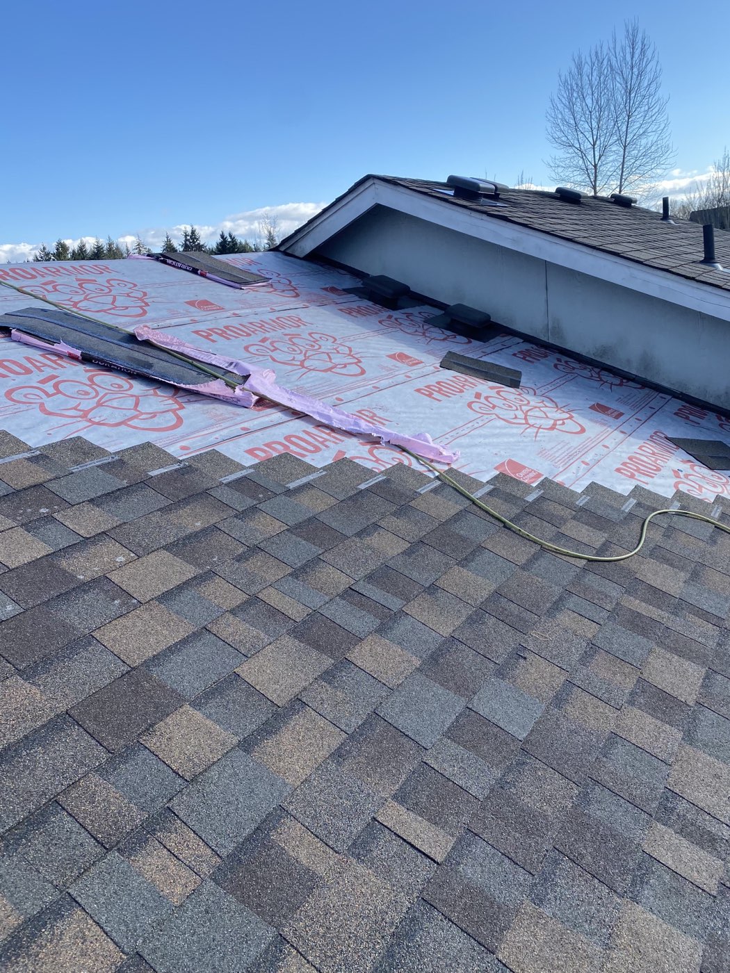 Peaks & Valleys crew mid-install: Owens Corning ProArmor underlayment and Duration shingles