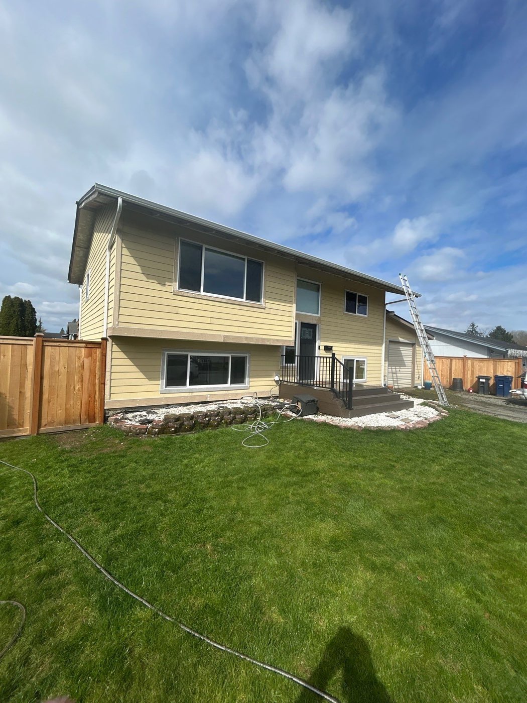 Siding and gutter work in progress on a split-level home